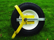 Milenco Lightweight Wheelclamp fitted to a wheel on a gravel driveway