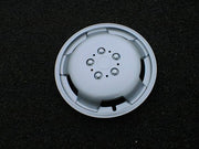 Milenco silver motorhome wheel trim photographed on tarmac