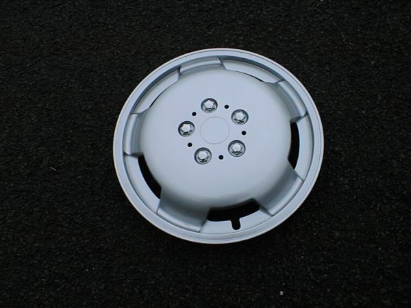 Milenco silver motorhome wheel trim photographed on tarmac