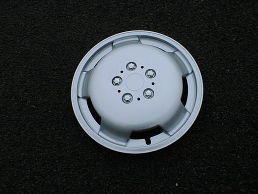 Milenco silver motorhome wheel trim photographed on tarmac