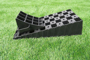 Milenco MGI Wedge Level ramp with its matching wheel chock, on grass