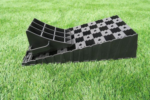 Milenco MGI Wedge Level ramp with its matching wheel chock, on grass