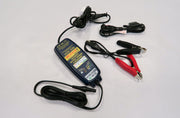 Milenco OptiMate 6 battery charger with power lead and crocodile clip connectors laid out