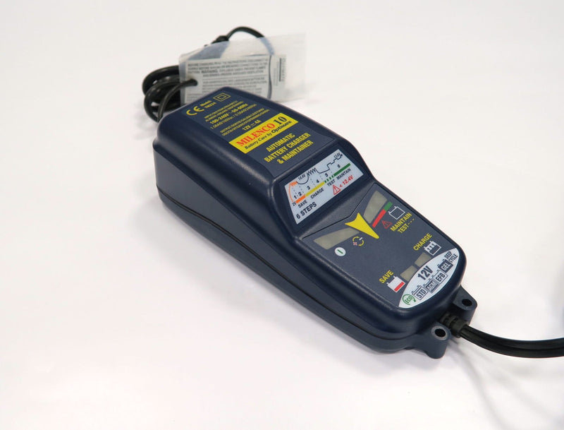 Milenco OptiMate 10 battery charger unit shown with mains lead and instruction leaflet
