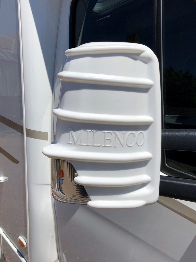 White Milenco mirror protector fitted to a motorhome mirror, close-up with embossed logo