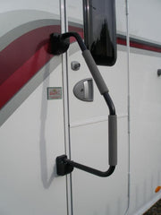 Milenco Safety Hand Rail XL fitted to a caravan door beside an Elite Caravans dealer sticker