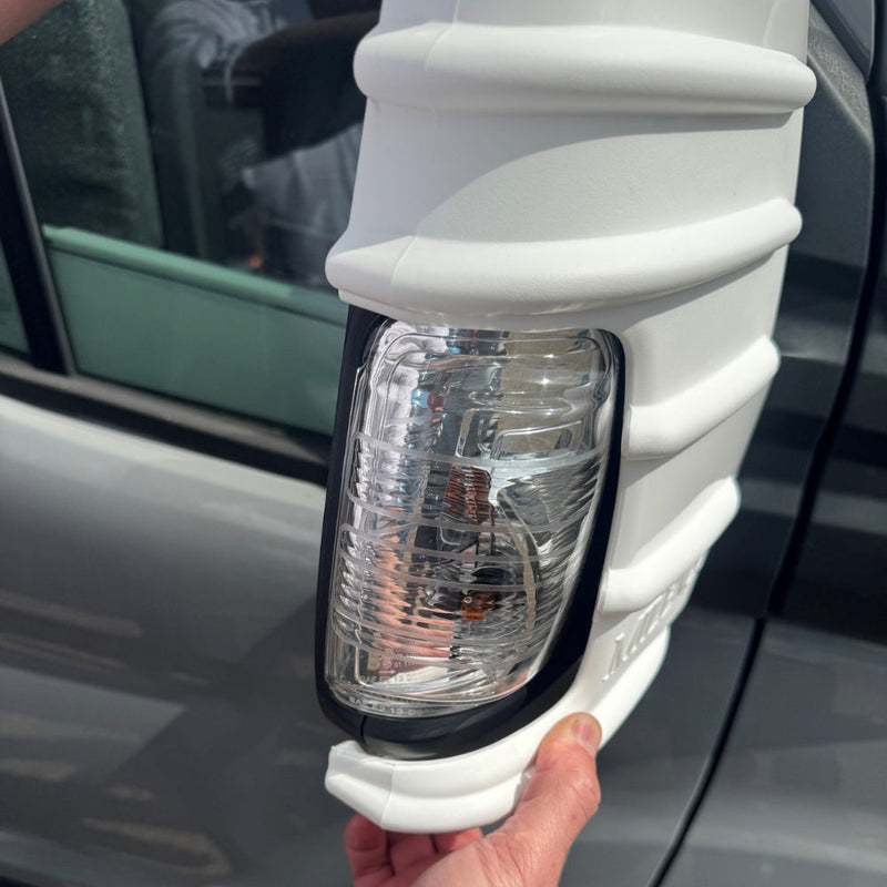 White Milenco mirror protector fitted to a Ford Transit mirror, close-up with indicator lens