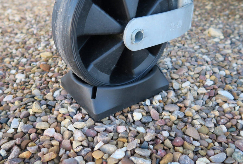 Milenco Jockey Pocket supporting a caravan jockey wheel on a gravel pitch