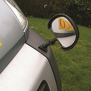 Milenco Vario 360 mirror screw-mounted to a car's front wing, garden background